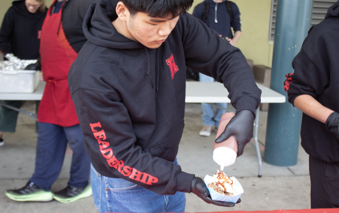 Leadership serves food to their peers at the cost of five dollars.
