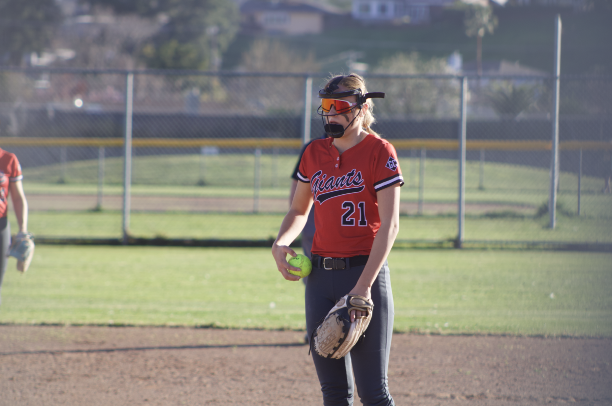 Taking a deep breath before pitching, junior Stella Belloumini centers herself and calms her nerves.
