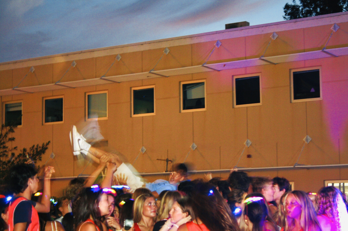 Students crowdsurf a classmate as the energy peaks during the BTSD.