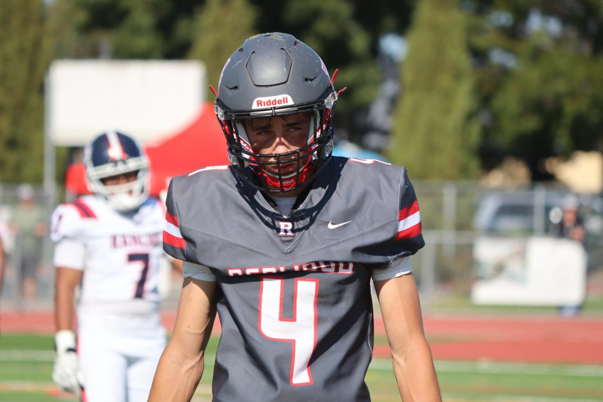 Senior Dylan McGrath (4) takes a breath between plays as he looks towards the coach for instruction.

