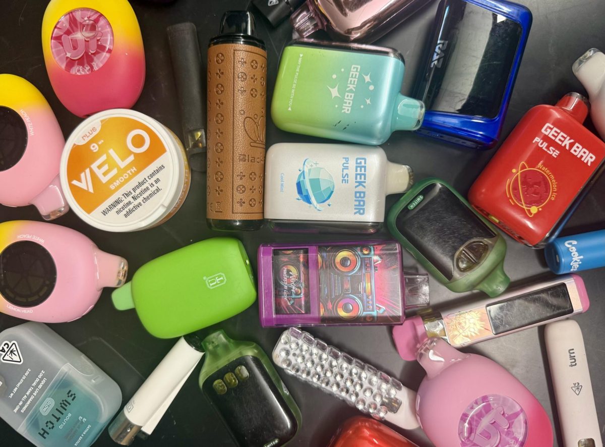 Vapes and Cannabis products that have been confiscated so far this year lie scattered across a table.