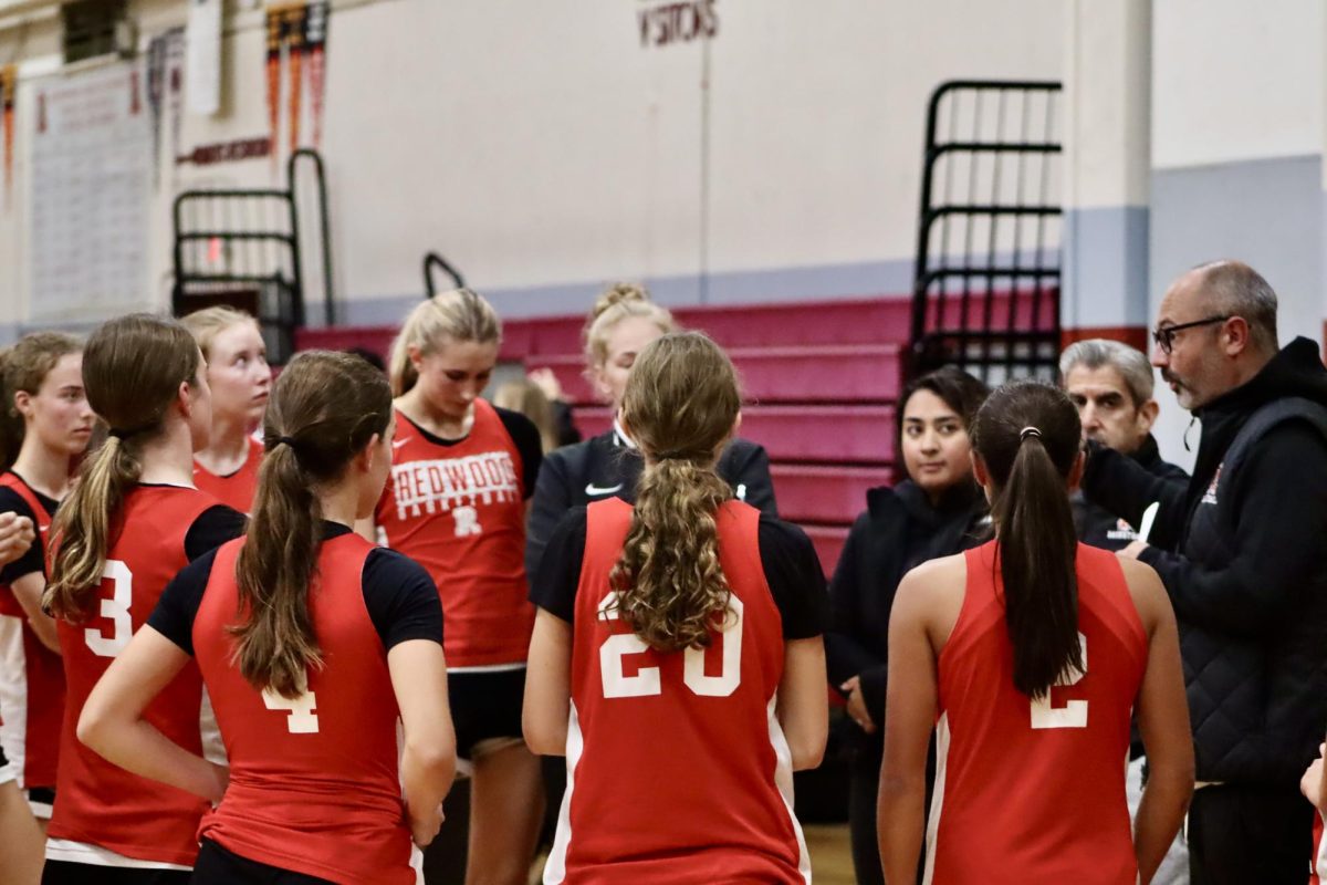 Huddled up during halftime, Coach Zach Borello discusses the team’s performance. 
