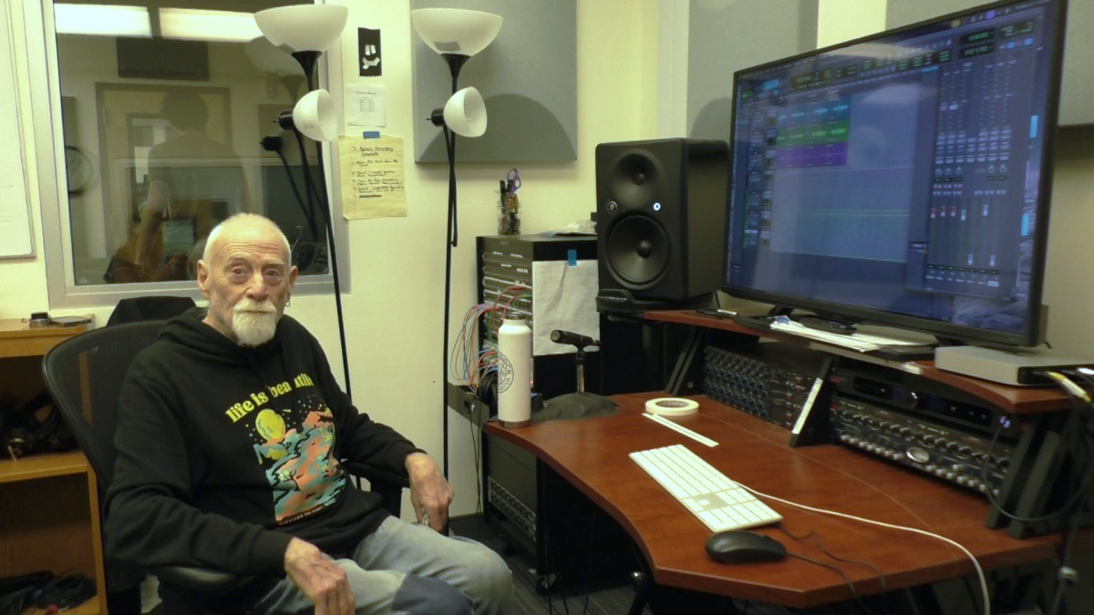 Arne Frager reclines in his studio after recording a college audition tape for senior Fred Bartle. Describing the studio as his “fourth instrument,” Frager says Redwood is the only high school in Marin with a real recording facility. (Nico Less)