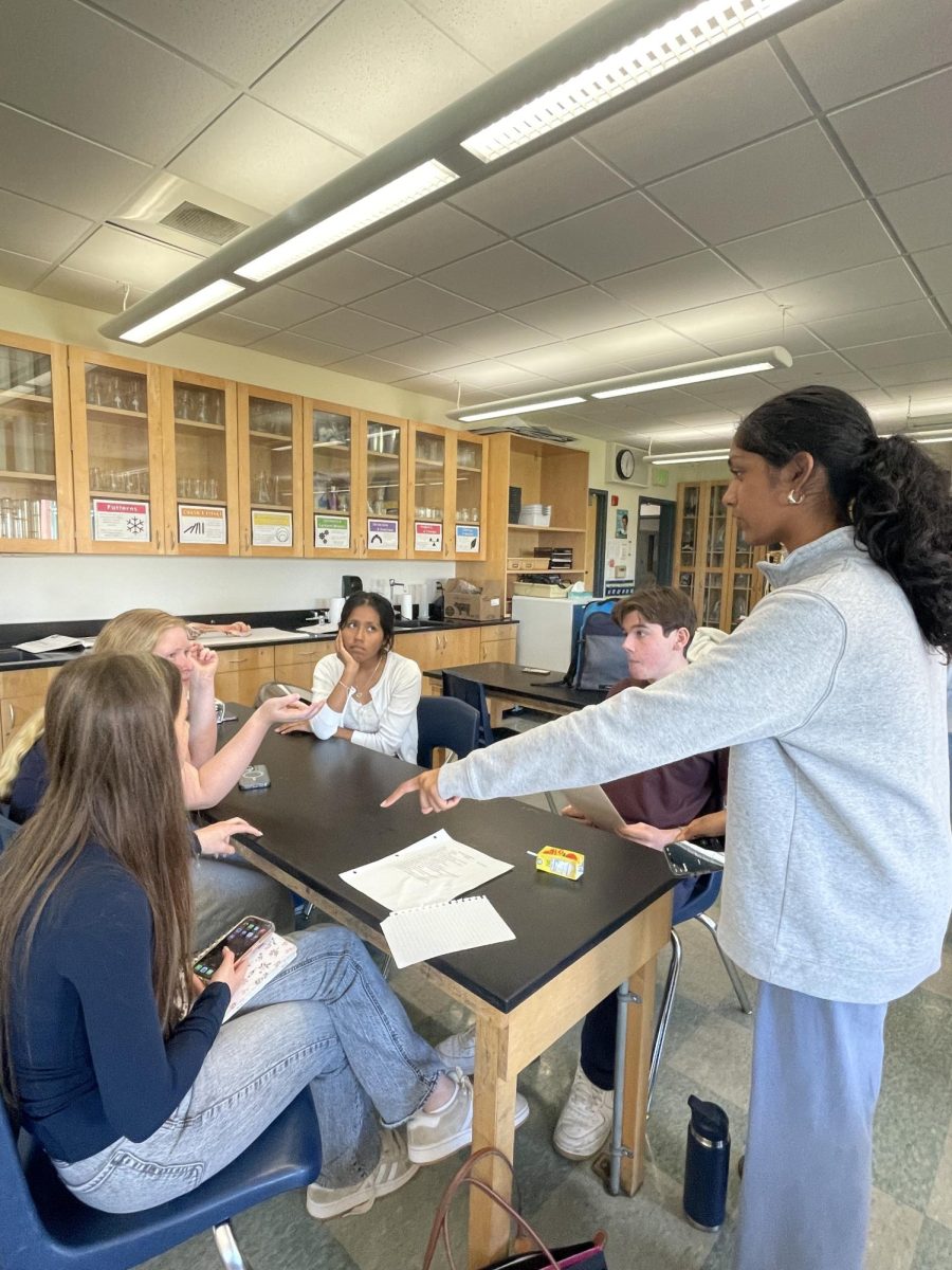 Sophomore secretary Veda Devulapalli advises club members during their first practice debate.