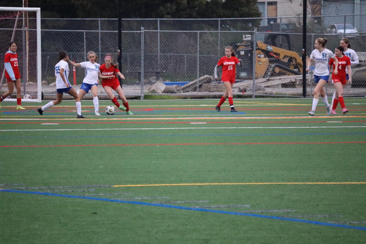 Freshman Daisy Forster attempts to steal the ball from a Branson attacker.
