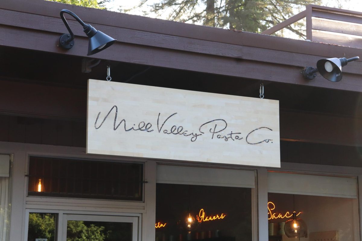 Mill Valley Pasta Company’s wooden exterior sign hangs above their Mill Valley location, offering a warm welcome to customers. 