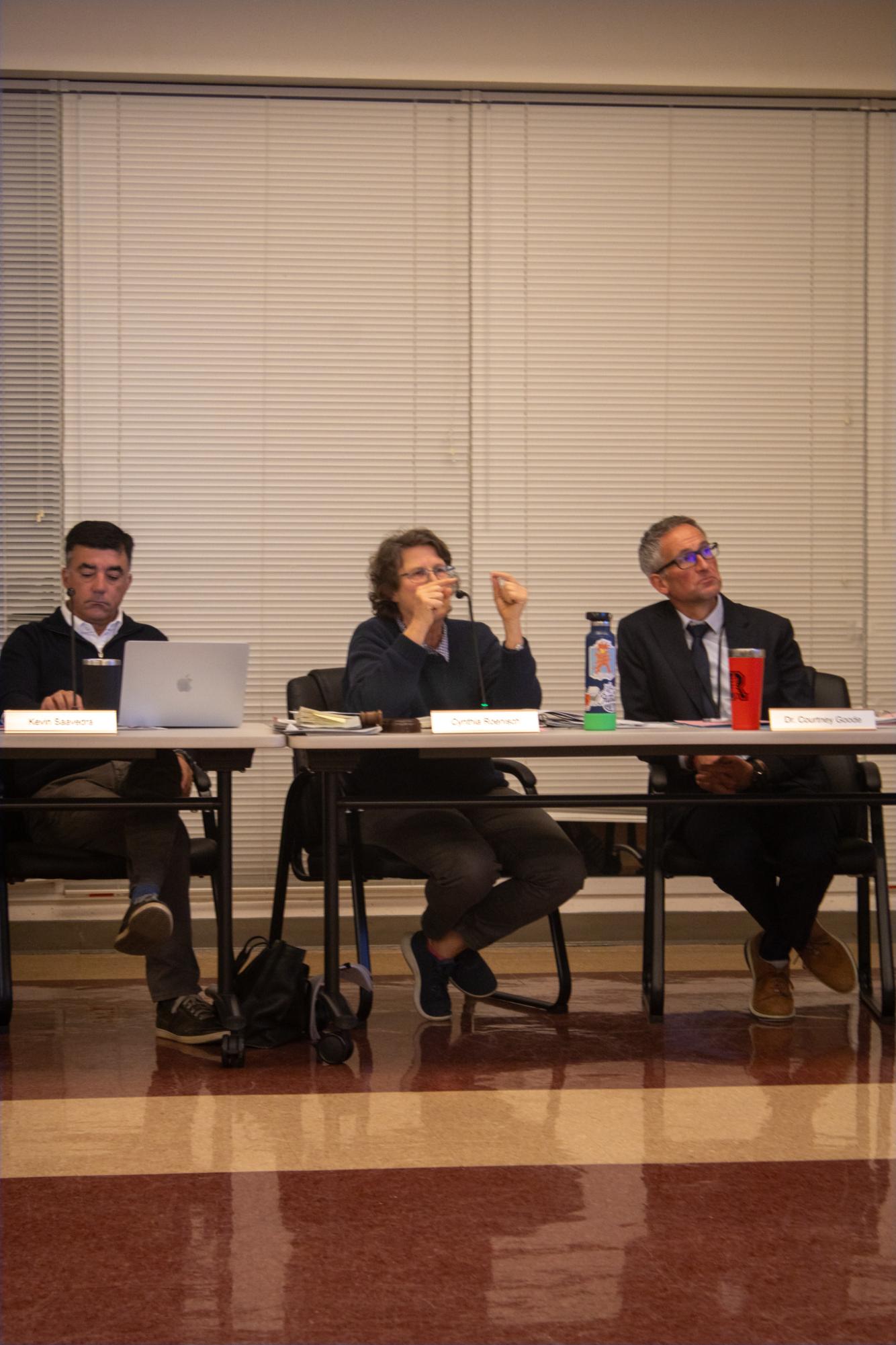 Board president Cynthia Roenisch (middle) speaks towards presenters during the AI Task Force presentation.