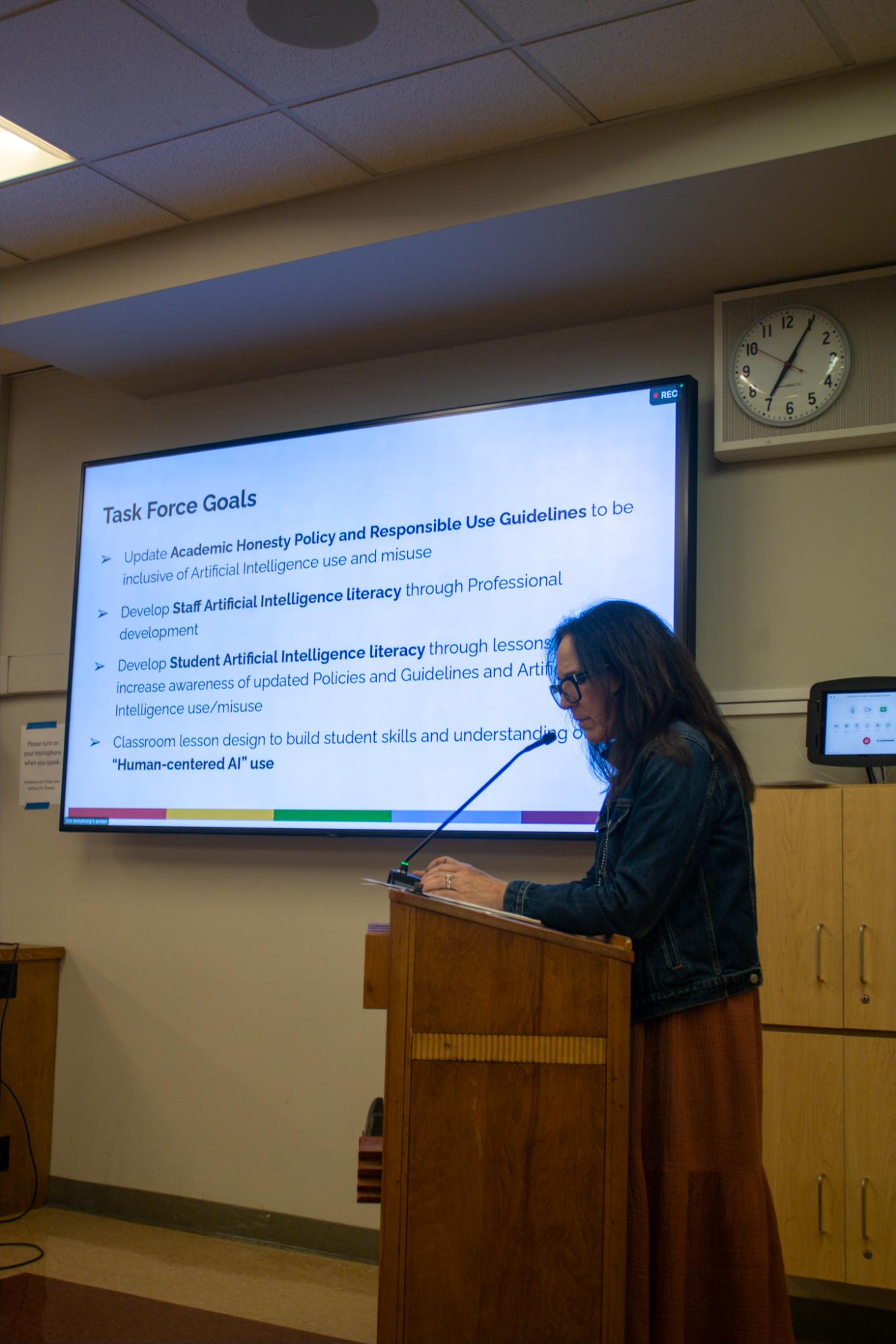 Senior Director of Curriculum and Instruction at Tamalpais Union High School District Paula Berry presents on the podium about the goals of the TUHSD’s new AI Task Force.