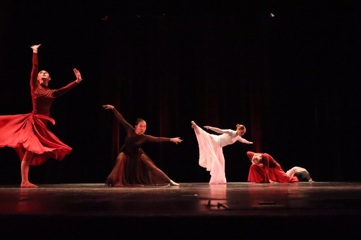 The most advanced jazz class’ dancers all strike their individual poses, spaced in a diagonal line on stage. 