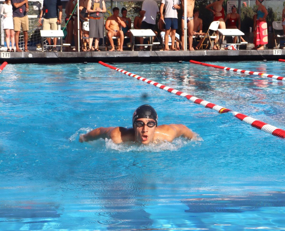 Sophomore Ilyas Fatullayev does the butterfly stroke in the 100 yard butterfly event.