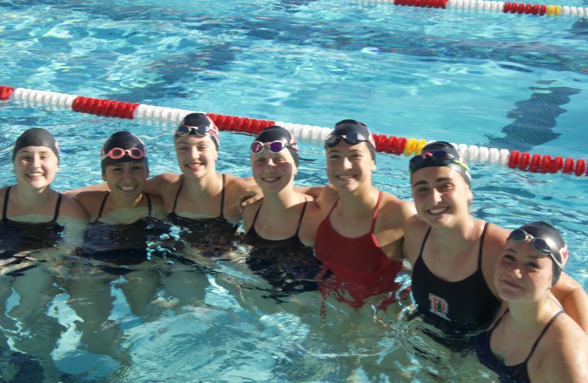 The girls' swim team poses for a quick photo before the meet begins.