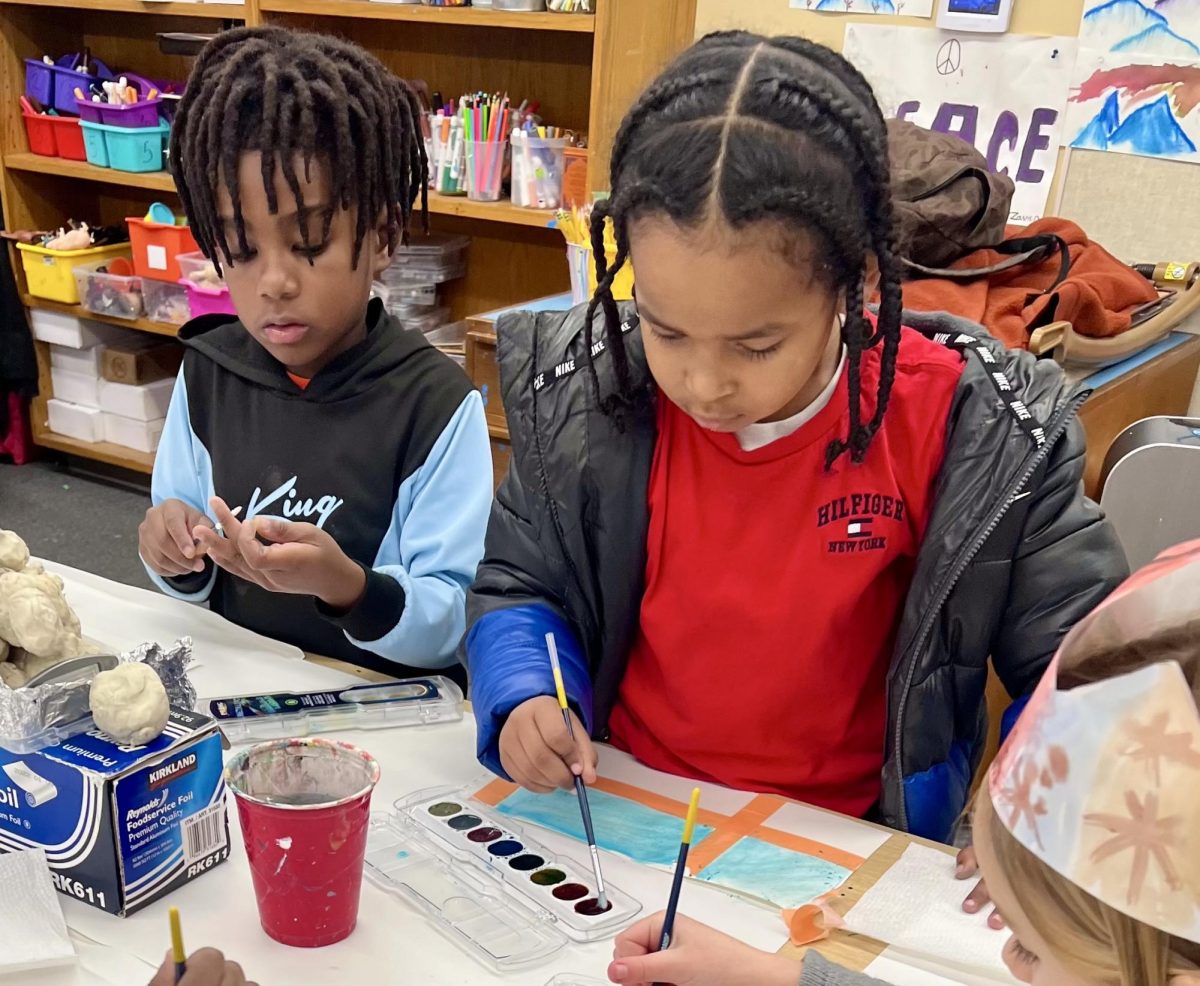 Kids painting watercolors in an arts and crafts activity that is part of the Bridge the Gap extended learning program (Photo courtesy of Lisa Raffel). 
