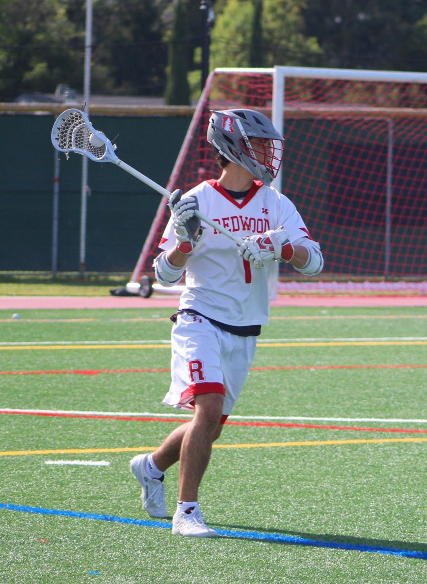Scanning the field for an open teammate, senior Tommy Vasquez looks to pass the ball.
