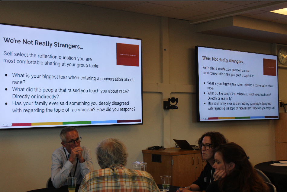 Attendees listen as presenter Cathy Flores leads a discussion about the societal norms surrounding racism.
