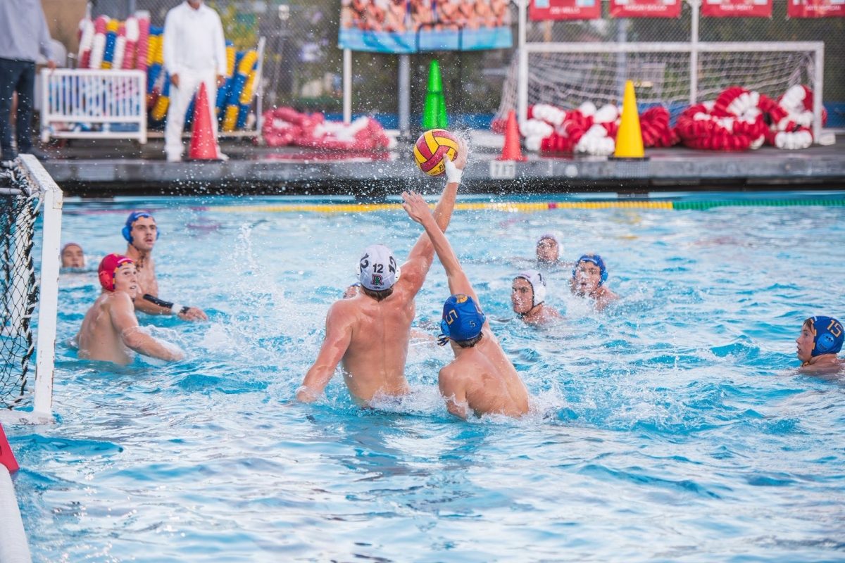 Reaching above the defense, senior Charles Poser rises for a shot.