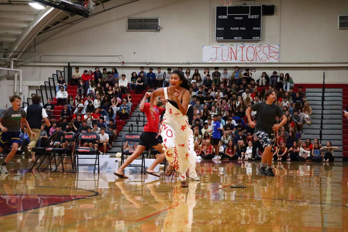 The rally included many games such as Snatch the Neon Bob, Finish the Lyric and musical chairs. Pictured are students playing Redwood’s version of musical chairs, where students run and find certain objects from the crowd.  