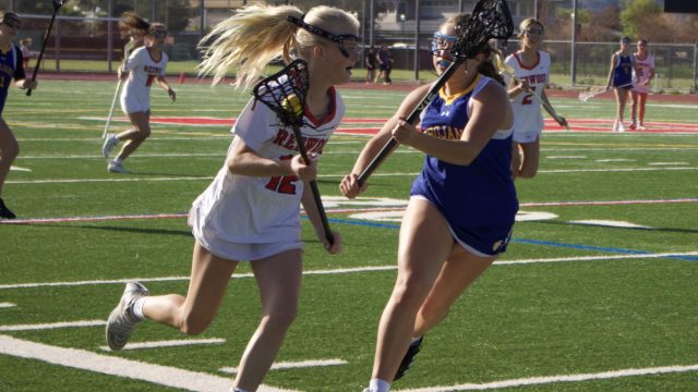 Sophomore Mimi Wood darts toward the goal holding the ball.