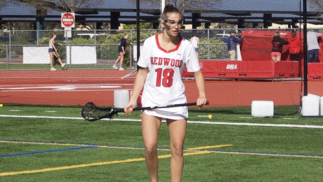 Staring at the ball, sophomore Gigi Walravens prepares to close in.