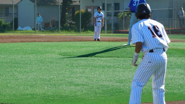 TJ Beck and Rex Solle look across the infield as they look to score.