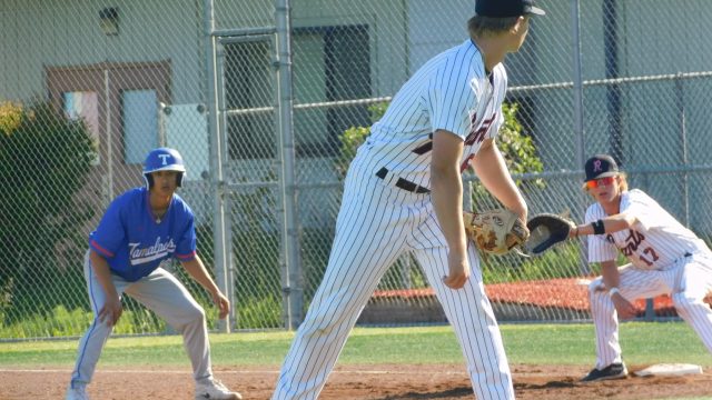 Rex Solle checks on the runner at first as Chase Johnson sets himself up for the pickoff.