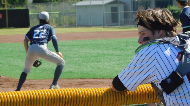 Sophomore catcher Ethan Ferry waits in the bullpen as the Wildcats warmup.