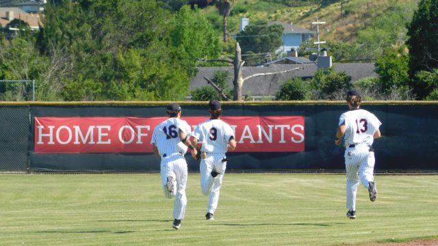 Junior TJ Beck, senior Gavin Soper (middle) and sophomore Jack Moseley (right) sprint to their positions following the national anthem.