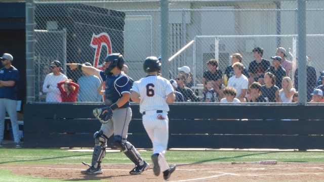 Jogging towards home, Rex Solle scores following a Giants’ single.