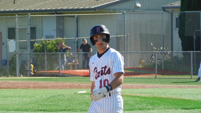 Junior Sam Gersch makes his way back to third base following a ball.