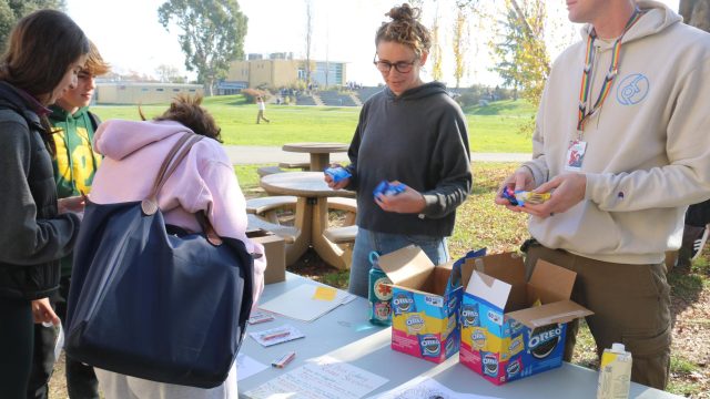 Wellness Coordinator Spencer DeWoody hands out Oreos to students during Wednesday’s Stress-Less event.